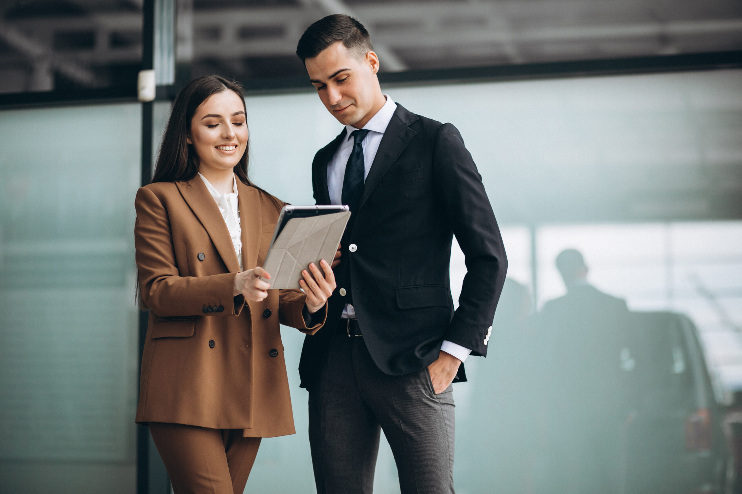 Male and female business people working on tablet in office